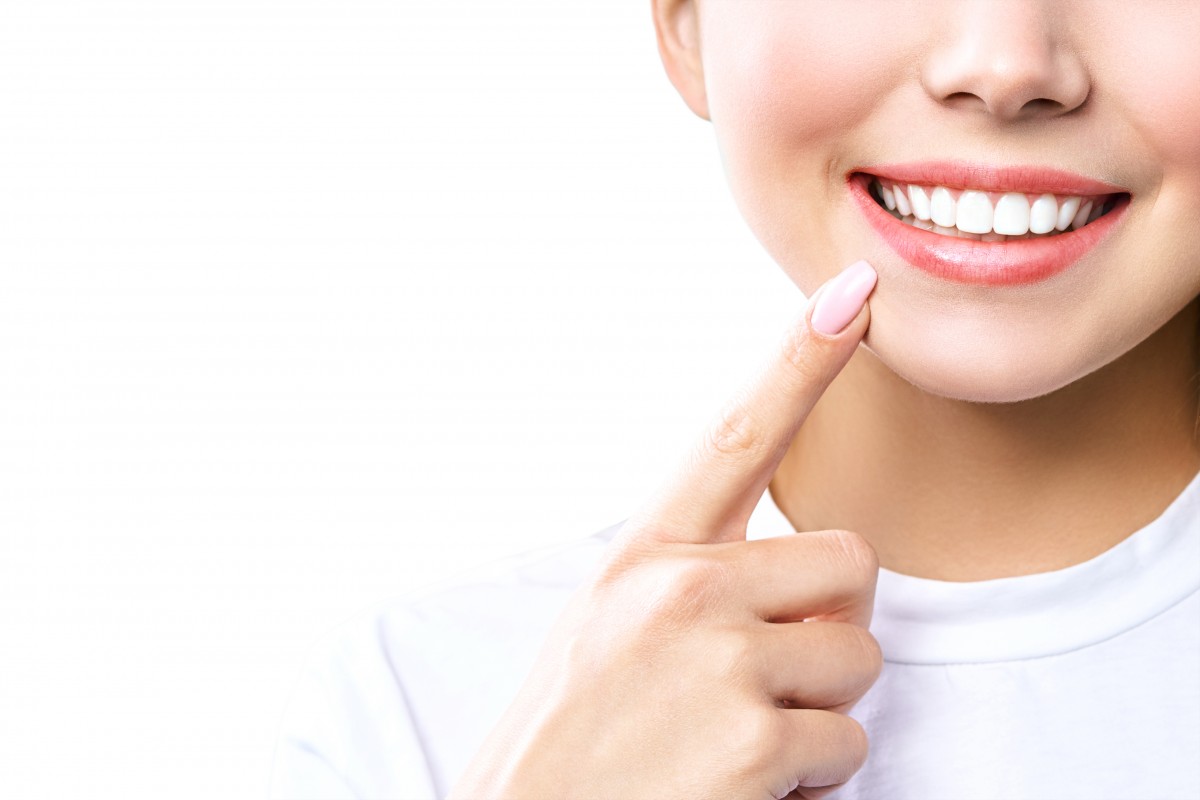 young-woman-isolated-white-background-showing-her-teeth